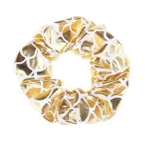 Detailed close-up of a gold and white fish scale pattern fabric hair scrunchie