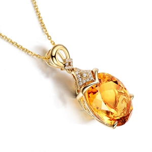 Close-up of golden pendant with a large oval yellow gemstone and sparkling zircon accents