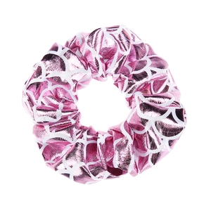 Close-up of pink metallic fish scale pattern scrunchie with elastic texture detail