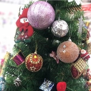 Macro detail of various festive Christmas ornaments on a decorated holiday tree branch