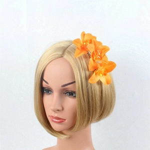Detail of vibrant orange orchid floral hair comb styled on a mannequin head