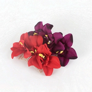 Detail of red and purple artificial orchid bridal hair combs with 20 teeth metal base