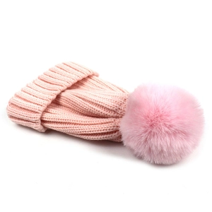 Pink knit beanie with fluffy pom pom for children and parents in warm wool yarn