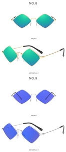 Detail view of rhombic metal sunglasses with green and blue mirrored lenses and thin frames