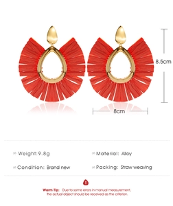 Detailed view of red raffia fan fringe earrings with gold drop studs and measurements
