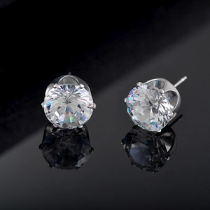 Macro shot of silver six-prong stud earrings with sparkling round cubic zirconia stones