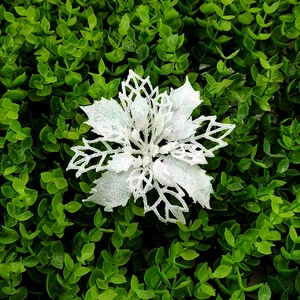 Close-up of white glitter hollow flower for Christmas tree and festive home decoration
