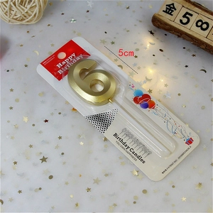 Detailed view of golden number 6 birthday candle in packaging with 5cm size marker