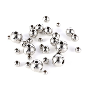 Macro shot of polished stainless steel beads with precision holes for jewelry making