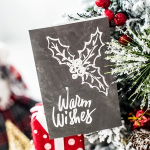 Vintage chalkboard style Christmas card with Warm Wishes text and holly leaf design