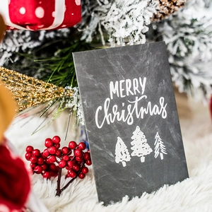 Vintage chalkboard Christmas card featuring three white trees and Merry Christmas text