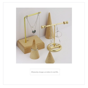 Elegant jewelry set with silver layered necklace, tassel earrings and feather ring on stands