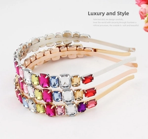 Detailed view of three metallic headbands with colorful rectangular rhinestones set in gold
