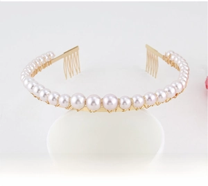 Detail of gold floral headband with white pearls and integrated hair comb attachment