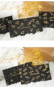 Detail of black Christmas card with gold foil stamping and Merry Christmas greeting