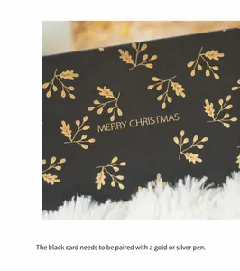 Detail of black Christmas card with gold foil leaf patterns and Merry Christmas text