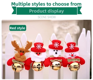 Detail of Christmas plush ornaments with Santa, reindeer and bells on white fence