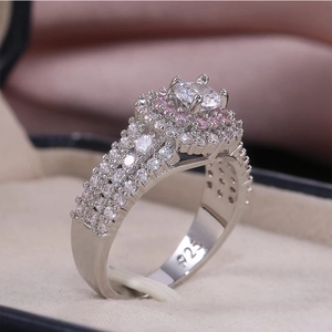 Close-up of S925 silver ring featuring pink cubic zirconia halo and macro pavé setting