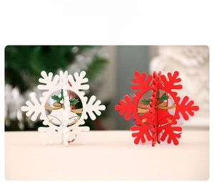 Detailed view of red and white 3D snowflake wooden pendants with festive bell motifs