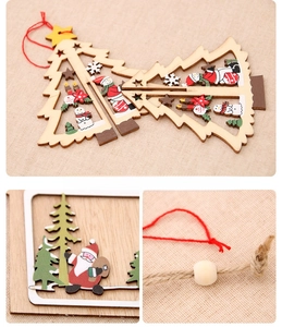 Close-up of laser-cut wooden Christmas tree ornaments with snowman and Santa motifs
