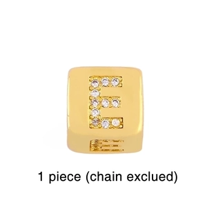 Close-up of a gold-plated dice charm with rhinestone letter E for DIY bracelets
