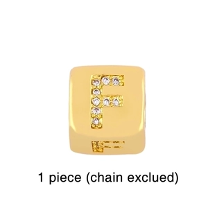 Detailed view of a gold square letter F charm with zircon inlay and back engraving