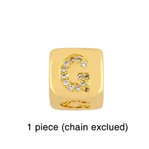Close-up of gold square charm with micro-paved zircon letter G for red cord bracelet
