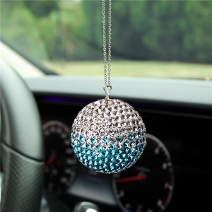 Close-up of sparkling silver and blue crystal ball car interior hanging ornament