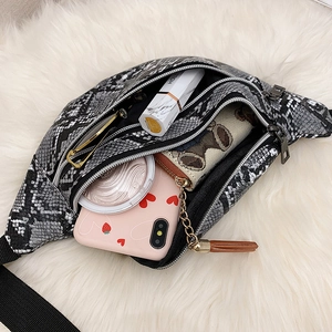 Women's faux snakeskin waist bag showing interior storage with makeup and phone