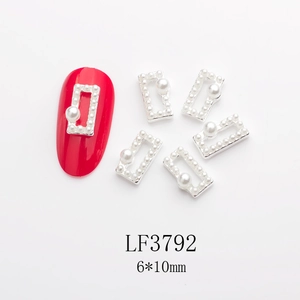 Detail of 6x10mm rectangular hollow metal nail charm with micro pearls and center inlay