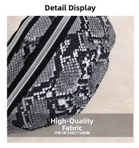 Close-up of snake skin texture and black zipper detail on a crossbody waist bag