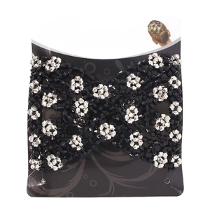 Detailed magic comb with black and silver beads arranged in a floral pattern on card