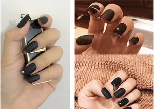 Punk style matte black long coffin nails with silver ring piercings and metal beads