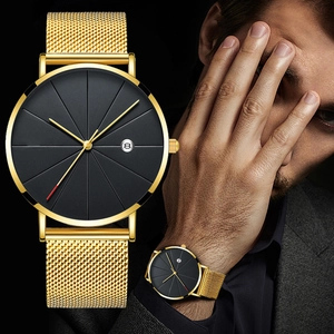 Detail view of men's watch with golden mesh strap, black dial, and date display feature