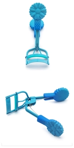 Detailed close-up of blue wide-angle eyelash curler with unique floral handle texture