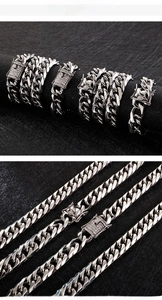 Close-up of silver cuban link chains with iced-out diamond clasps on black texture