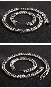 Detailed view of silver Cuban link chain set with sparkling diamond encrusted clasps