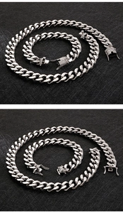 Close-up of silver Cuban link necklace and bracelet set with diamond-encrusted clasps