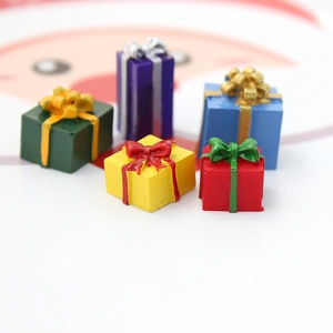 Macro shot of colorful miniature resin gift boxes with decorative bows for DIY crafts