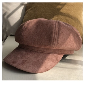 Detail showing the thick faux suede texture and rich pink-red hue of the newsboy hat