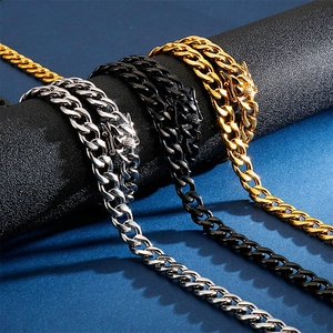 Cuban link chains in silver, gold and black stainless steel on a display stand