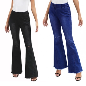 Detail of high waisted flare jeans featuring distressed knee holes and frayed hems