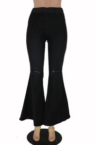 Close-up of black high-waisted distressed bell bottom jeans with ripped knee detail