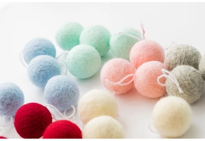 Macro shot of colorful wool felt balls with white string for DIY Christmas decor