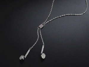 Detail of silver rock music headphone pendant necklace with textured metallic finish