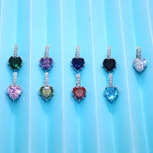 Macro shot of nine multi-colored zircon heart earrings with classic prong settings