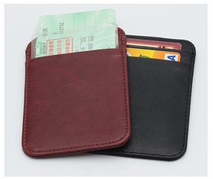 Close-up of slim leather card holder featuring multiple slots for IDs and credit cards