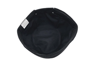 Detail view of the 100% cotton inner lining and wash care label of the black sailor cap