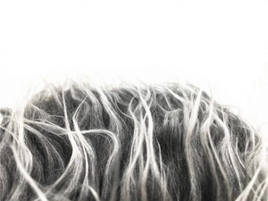 Macro texture of fluffy grey and white synthetic fiber on a retro sailor beanie hat