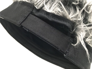 Detail of adjustable Velcro strap and gray faux hair on the black docker cap